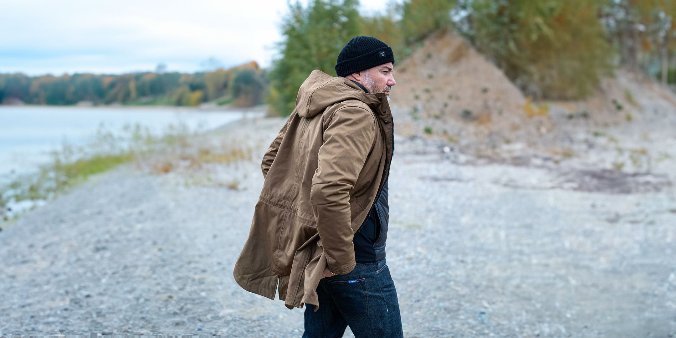 CADUFF Japanese Double-Knit 2-in-1 Winter Parka — side view at a winter lake with the removable ECO DOWN liner visible; water-repellent and wind-resistant.