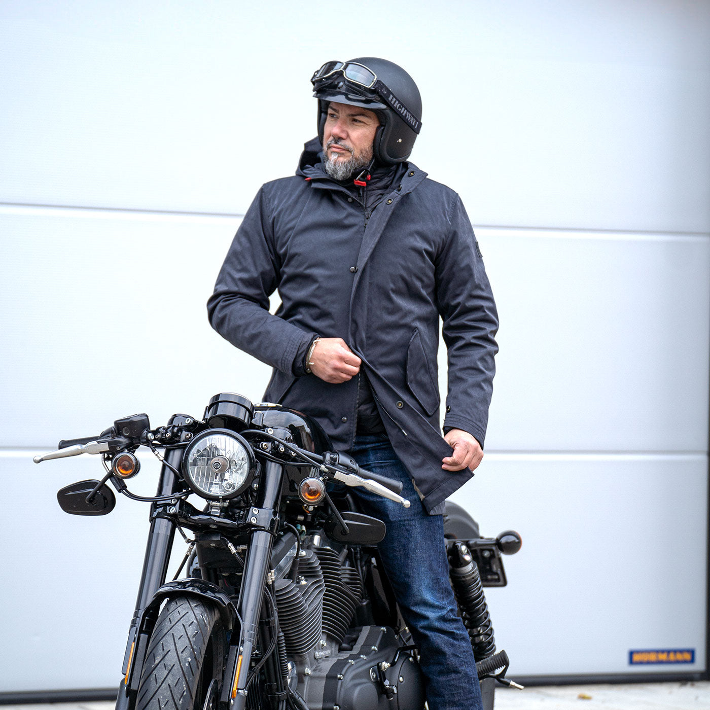 Salute Blue CADUFF 2-in-1 Winter Parka with YKK METALUX® two-way zipper opened from the bottom for seated comfort on a Harley motorcycle.
