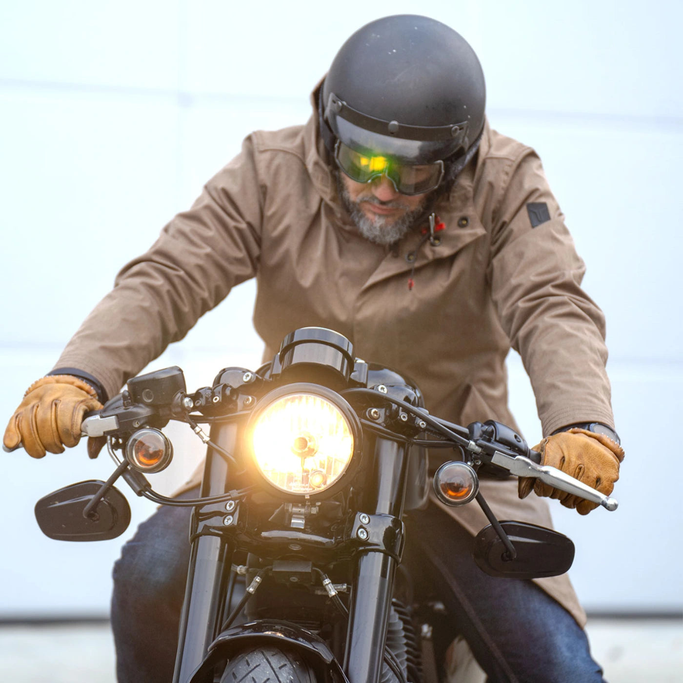 Model wearing the Brown CADUFF Japanese Double-Knit 2-in-1 Winter Parka on a motorcycle; knit softens and conforms over time for a personal patina; water-repellent and wind-resistant.