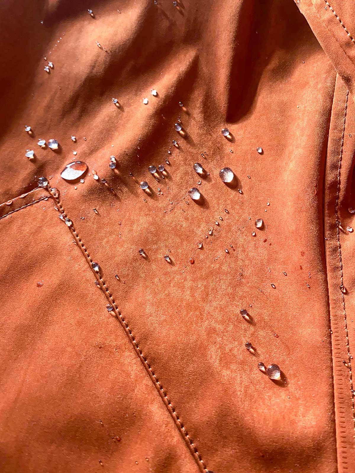 Close-up of CADUFF Japanese Double-Knit 2-in-1 Winter Parka — Ginger, water-repellent finish with beads on the fabric; breathable, wind-resistant.